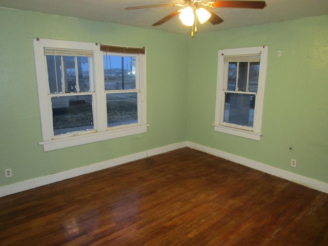 711 N 10th St, Memphis, TX 79245 - unfurnished room with baseboards, dark wood-style flooring, and ceiling fan