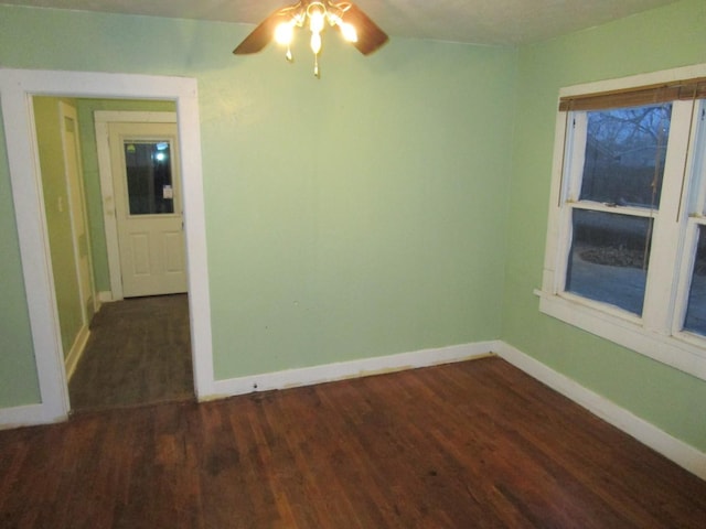 711 N 10th St, Memphis, TX 79245 - empty room featuring dark wood-style floors, a ceiling fan, and baseboards