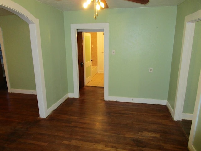 711 N 10th St, Memphis, TX 79245 - spare room featuring arched walkways, ceiling fan, baseboards, and wood finished floors