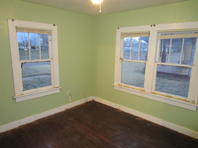 711 N 10th St, Memphis, TX 79245 - spare room with baseboards and dark wood-type flooring