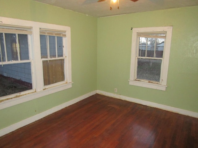 711 N 10th St, Memphis, TX 79245 - spare room with dark wood-style floors, baseboards, and ceiling fan