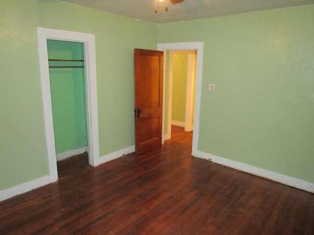711 N 10th St, Memphis, TX 79245 - unfurnished bedroom featuring dark wood finished floors, a closet, and baseboards