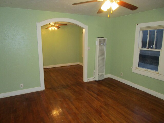 711 N 10th St, Memphis, TX 79245 - spare room with arched walkways, baseboards, ceiling fan, and wood finished floors