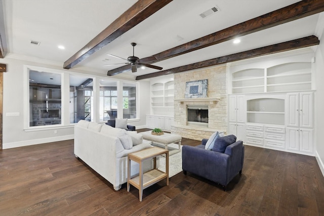 living room with dark wood-style floors, visible vents, a stone fireplace, and baseboards