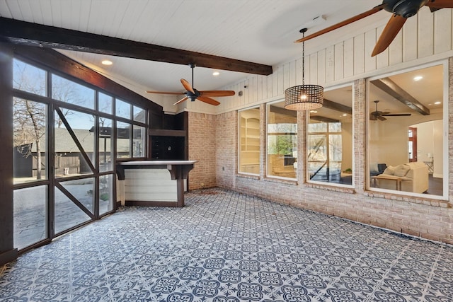 unfurnished sunroom with beamed ceiling and ceiling fan