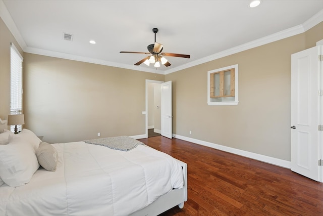 bedroom featuring visible vents, baseboards, wood finished floors, and ornamental molding