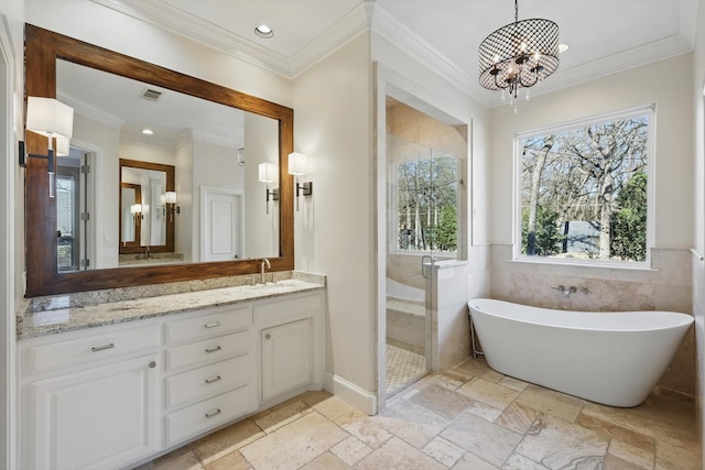 bathroom with stone tile floors, recessed lighting, a shower stall, and vanity