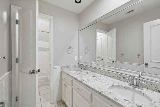 full bath with double vanity, visible vents, tile patterned flooring, and a sink