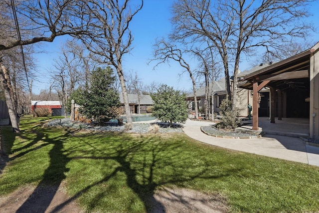 view of yard with a swimming pool and a patio