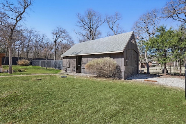 exterior space featuring an outbuilding, fence, and a barn