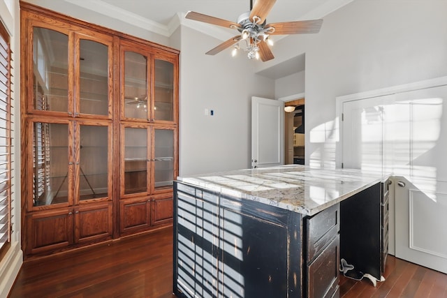 kitchen with crown molding, glass insert cabinets, dark wood-style flooring, and light stone countertops