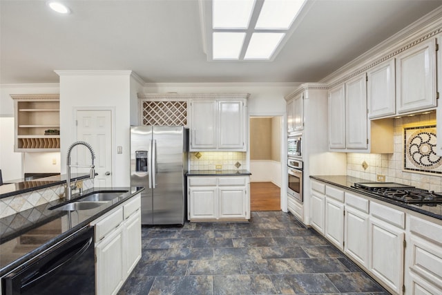 kitchen with a sink, stone finish flooring, dark stone countertops, appliances with stainless steel finishes, and open shelves