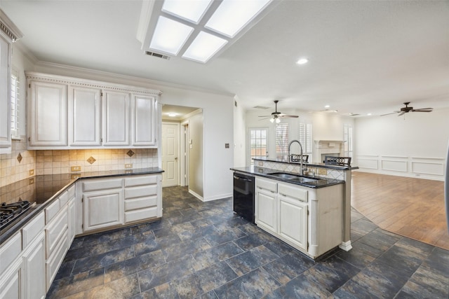 kitchen featuring dark countertops, backsplash, open floor plan, dishwasher, and a sink