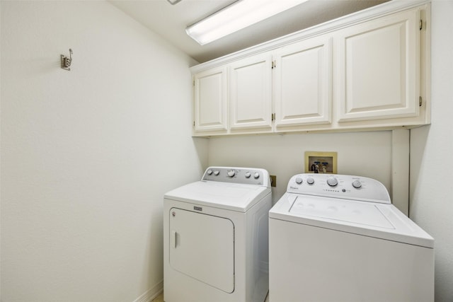 laundry room with washer and clothes dryer and cabinet space