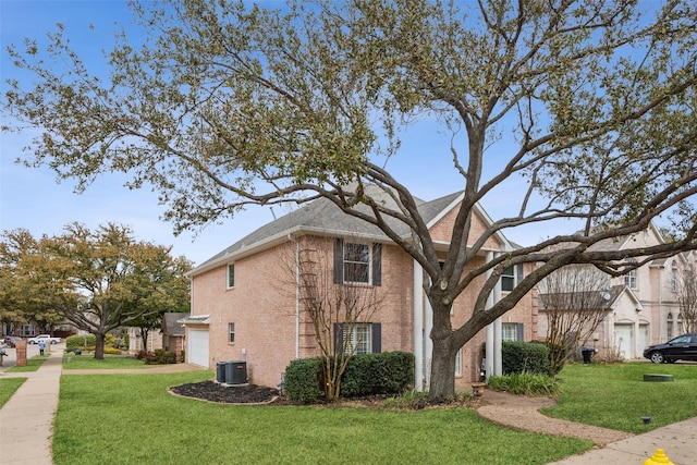 view of side of property featuring brick siding, a garage, central AC unit, and a lawn