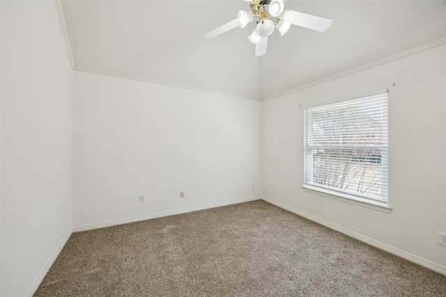 carpeted empty room featuring vaulted ceiling, a ceiling fan, baseboards, and ornamental molding