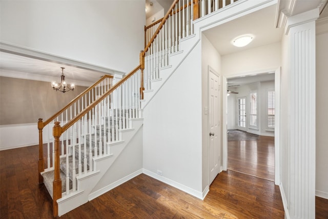 stairway featuring hardwood / wood-style flooring and baseboards