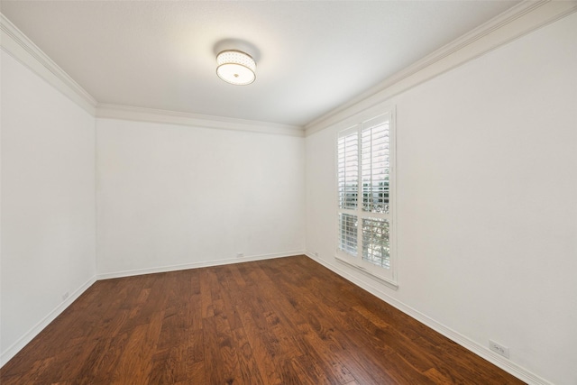 empty room featuring dark wood-style floors, baseboards, and ornamental molding