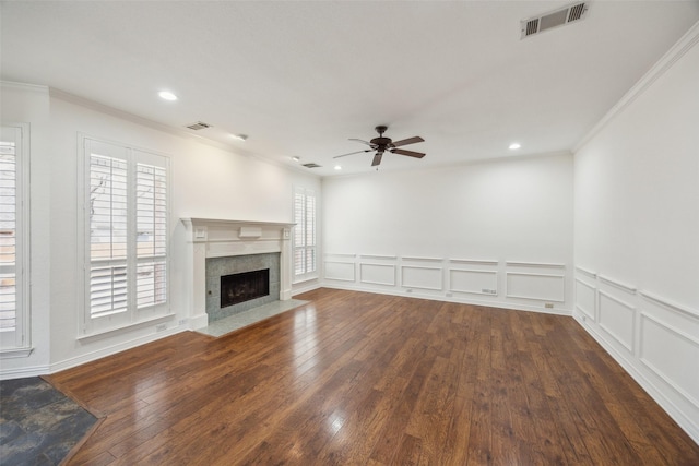 unfurnished living room featuring hardwood / wood-style floors, plenty of natural light, and visible vents