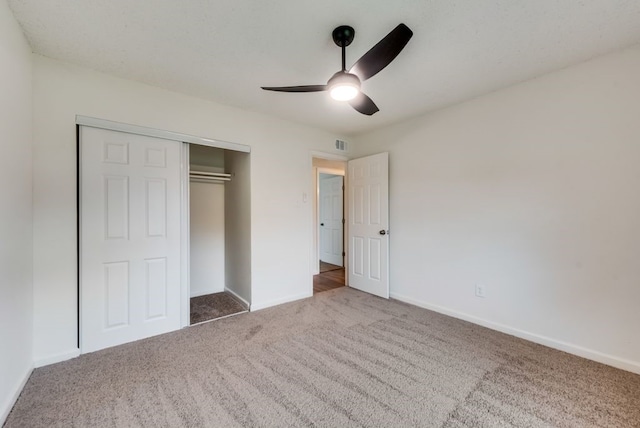 unfurnished bedroom featuring a closet, baseboards, visible vents, and carpet flooring