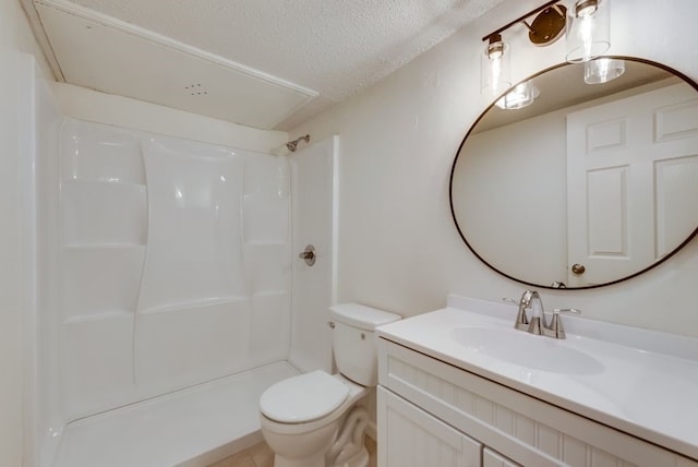 bathroom featuring vanity, toilet, a shower, and a textured ceiling