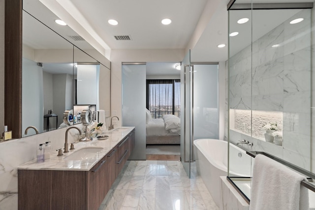 bathroom with a sink, visible vents, a soaking tub, and marble finish floor