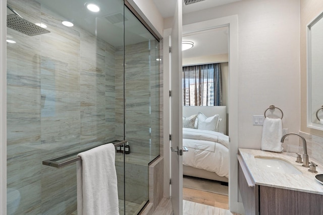 ensuite bathroom featuring vanity, ensuite bath, visible vents, and a stall shower