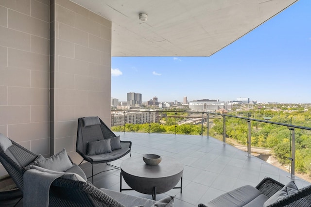 balcony with an outdoor living space and a view of city