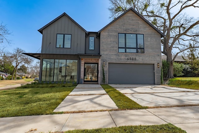 view of front of house featuring a garage, a front lawn, board and batten siding, and driveway