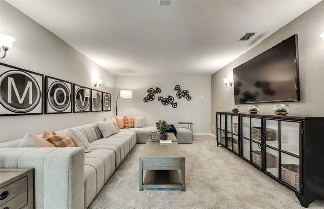 carpeted living area with baseboards and visible vents