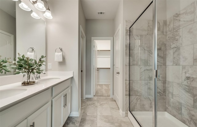 bathroom featuring visible vents, marble finish floor, a stall shower, and a sink