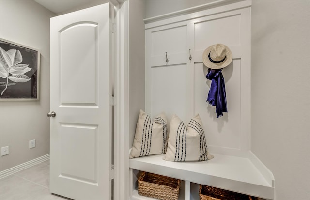 mudroom featuring light tile patterned flooring and baseboards