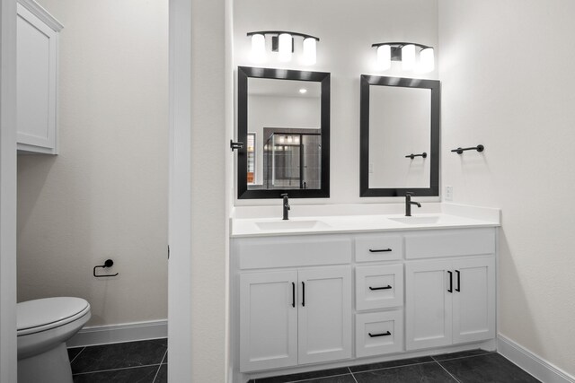 3100 Colt Ln, Celina, TX 75009 - bathroom with tile patterned floors, toilet, double vanity, and baseboards