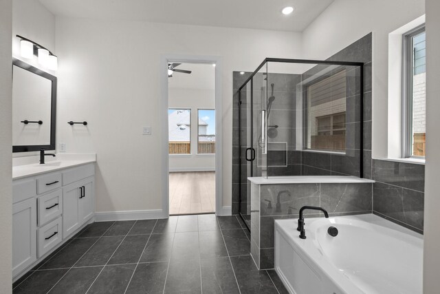 3100 Colt Ln, Celina, TX 75009 - bathroom with vanity, a garden tub, a shower stall, tile patterned flooring, and baseboards