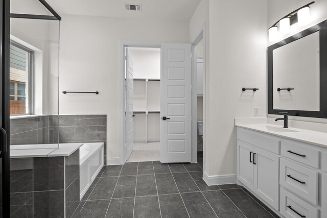 3100 Colt Ln, Celina, TX 75009 - bathroom with vanity, a garden tub, baseboards, tile patterned floors, and toilet