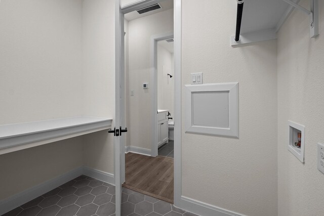 3100 Colt Ln, Celina, TX 75009 - laundry room with washer hookup, dark tile patterned floors, and baseboards