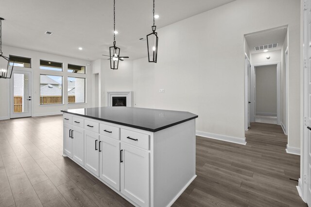 3100 Colt Ln, Celina, TX 75009 - kitchen with a ceiling fan, dark countertops, dark wood finished floors, a fireplace, and open floor plan