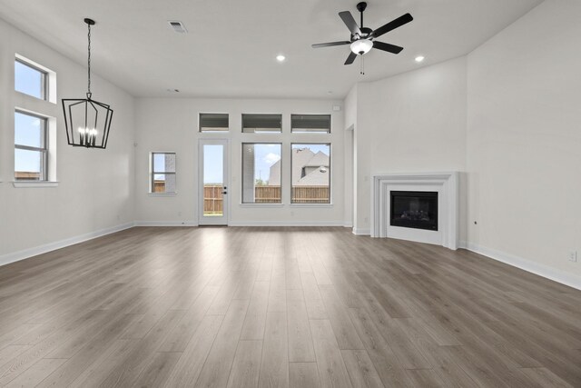 3100 Colt Ln, Celina, TX 75009 - unfurnished living room featuring a chandelier, wood finished floors, a ceiling fan, baseboards, and recessed lighting