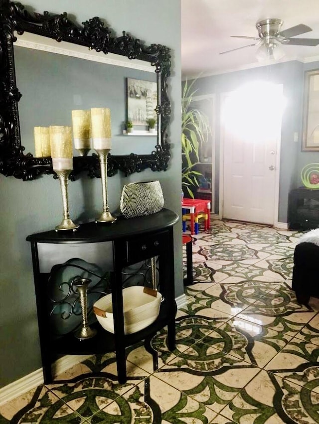 interior space featuring ceiling fan and baseboards