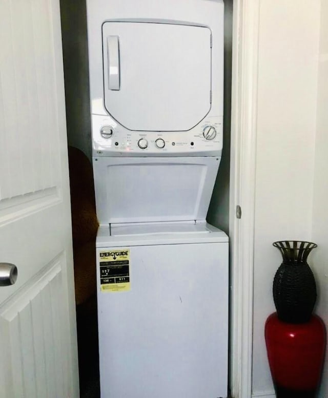 laundry area featuring laundry area and stacked washer / dryer