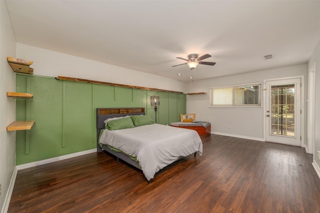 bedroom featuring visible vents, baseboards, wood finished floors, a ceiling fan, and access to outside