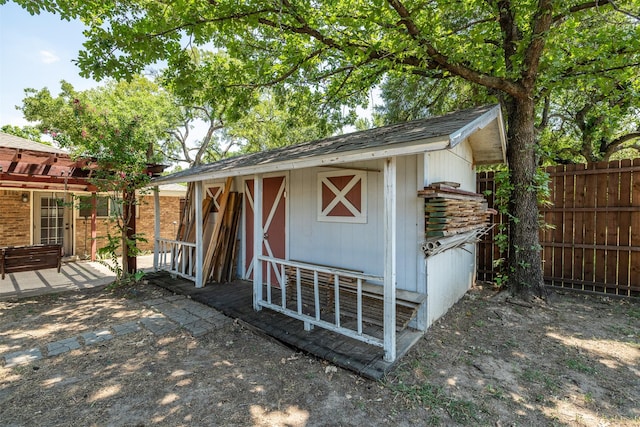 view of outbuilding featuring an outbuilding and fence