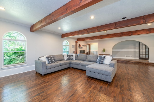 living area featuring beamed ceiling, wood finished floors, baseboards, and a textured ceiling