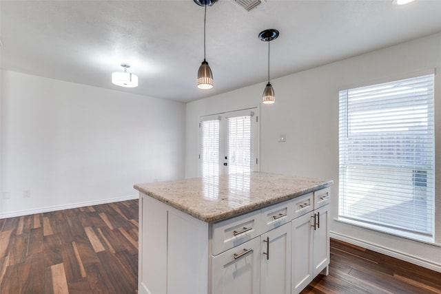 kitchen featuring dark wood finished floors, french doors, white cabinetry, and pendant lighting