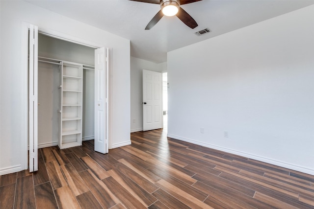 unfurnished bedroom with visible vents, a ceiling fan, a closet, baseboards, and dark wood-style flooring