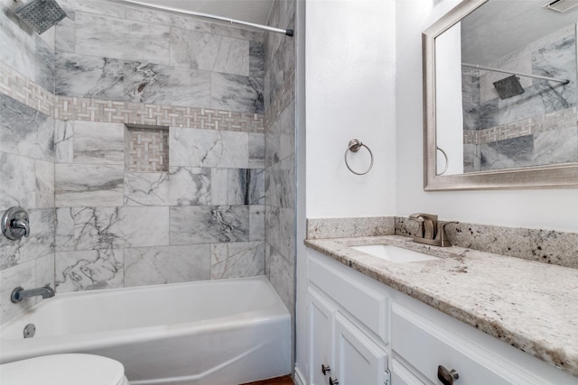 bathroom featuring toilet, vanity, and bathtub / shower combination