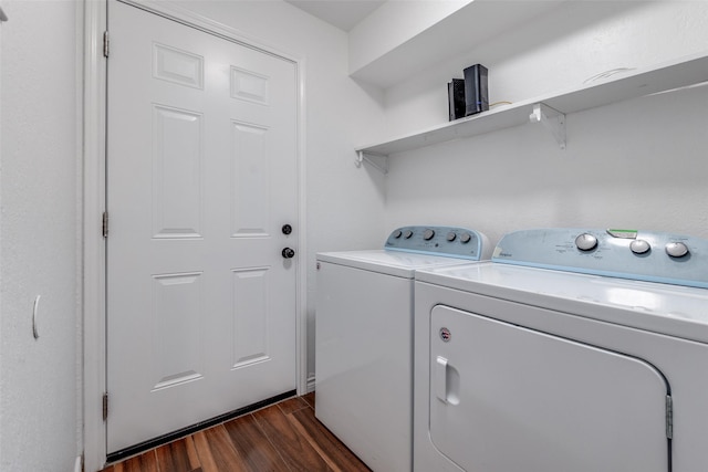 washroom featuring separate washer and dryer, dark wood-style floors, and laundry area