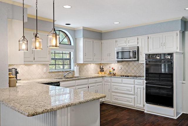 kitchen featuring dark wood-type flooring, light stone counters, a peninsula, black appliances, and a sink