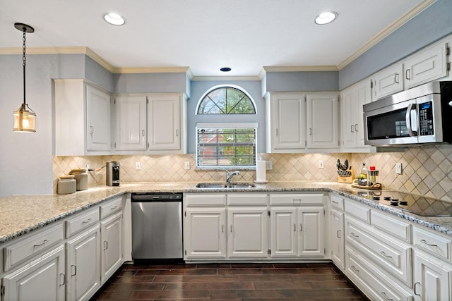 kitchen with a sink, wood finish floors, white cabinetry, and stainless steel appliances