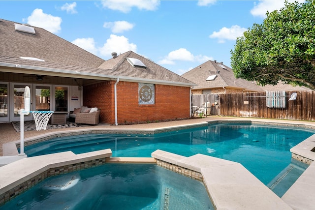 view of pool featuring a patio area, fence, an outdoor living space, and a pool with connected hot tub